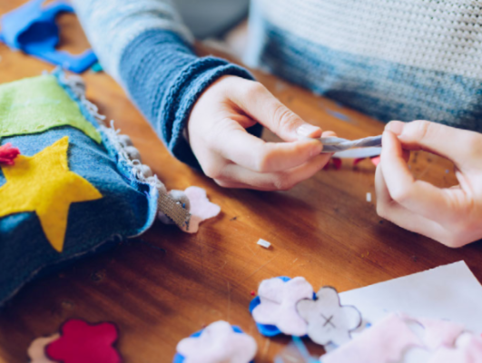 hands of a child who sews