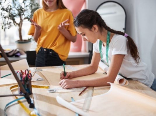 girl making a pattern on paper