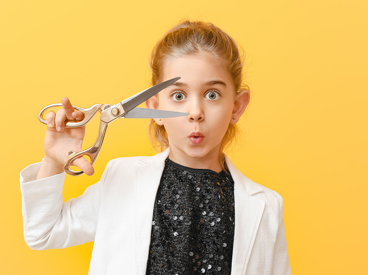 A child with scissors ready to cut